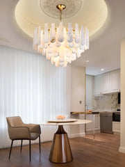 A modern gold led dimmable chandelier with cascading white marble shades from the dimmable marble collection for dining room