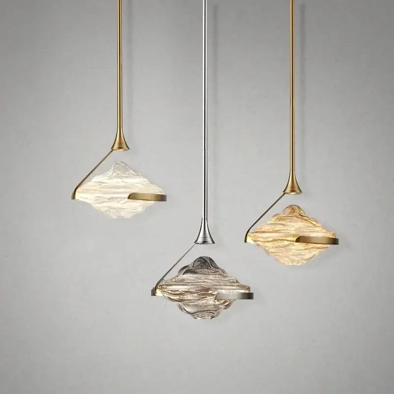 Three modern decorbites gold led pendant lamps with textured translucent glass shades for dining room decor