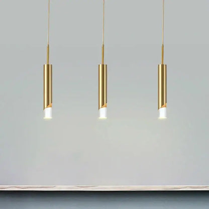 Three sleek gold led pendant lights by decorbites with cylindrical design hang in a modern dining room decor