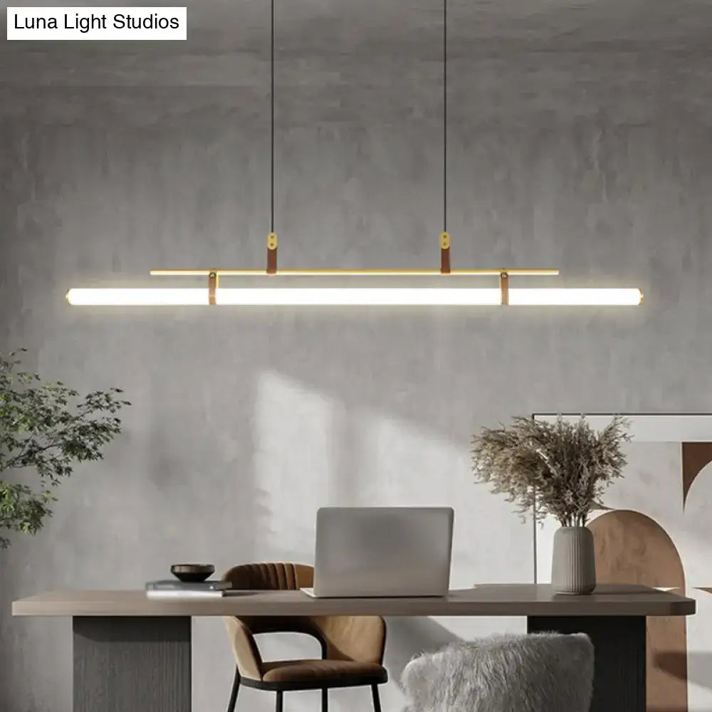 Modern gold led pendant light with brass accents and warm white illumination for dining room suspended by black cords