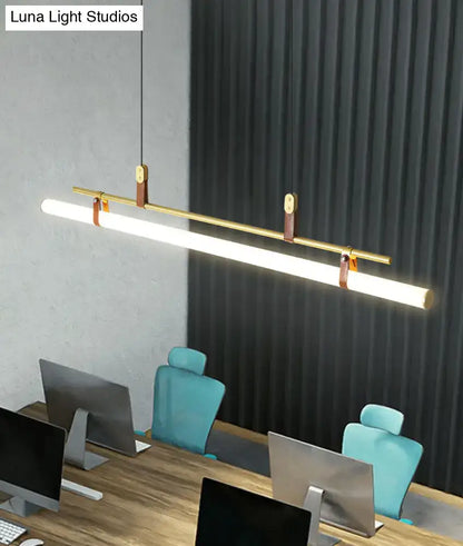 Modern gold led pendant light with leather straps and brass accents designed for a stylish dining room setting
