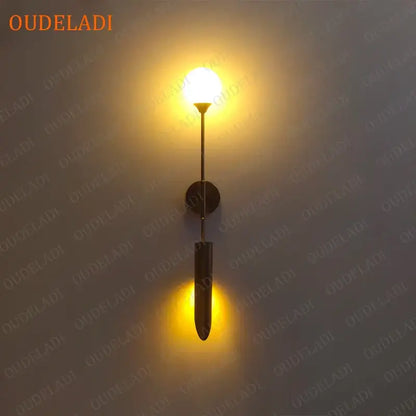 Modern gold led wall lamp with warm-toned brass elongated design and circular mounting plate for living room use