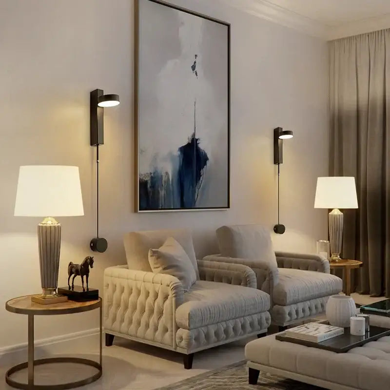 Cream-colored tufted armchairs paired with a modern gold led wall lamp with dimming switch from decorbites gold led collection