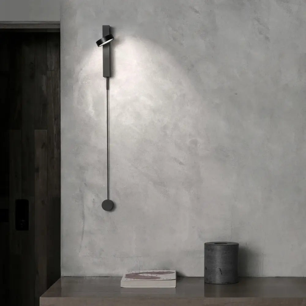 Minimalist black wall lamp with sleek elongated design and circular base featuring dimming switch for decorbites gold led bedroom use