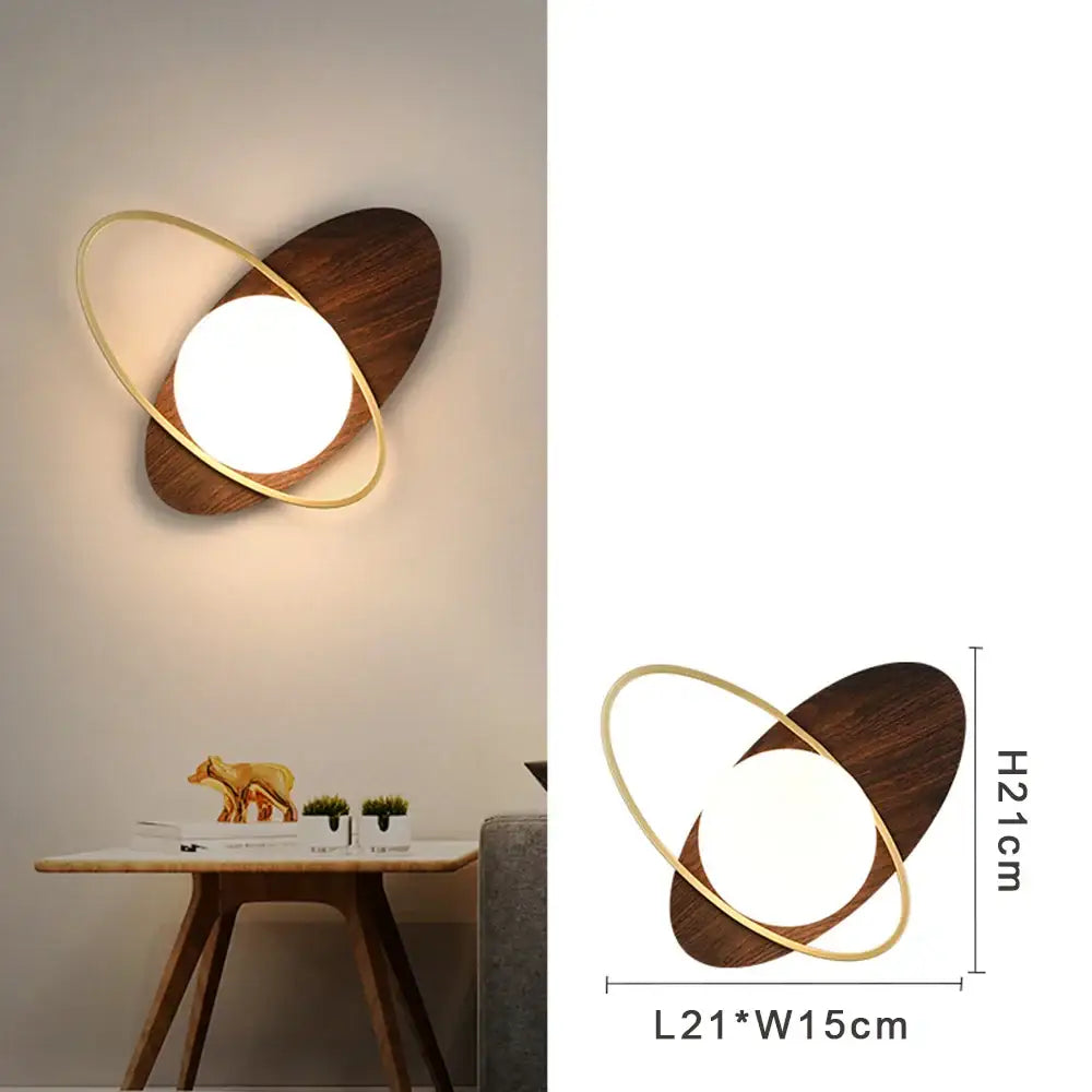 Modern gold led wall lamp with frosted glass, featuring a dark wood oval base and metallic ring led wall lamp