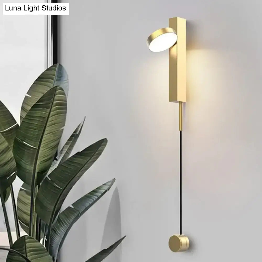 Modern gold led wall lamps featuring a gold-toned minimalist rectangular base, slender black cord, and rotating circular light head