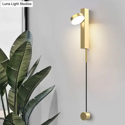Modern gold led wall lamps featuring a gold-toned minimalist rectangular base, slender black cord, and rotating circular light head