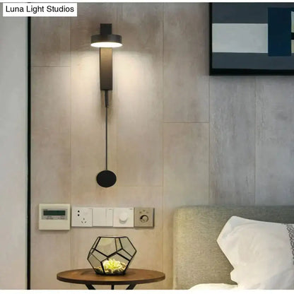 Modern black led wall lamp with sleek minimalist design and adjustable pull cord as a rotating bedroom wall lamp