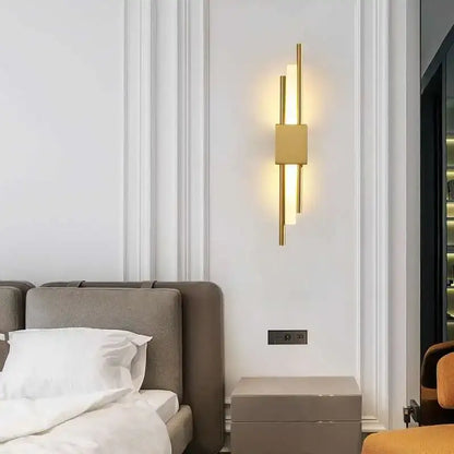 Modern gold led wall sconce with vertical cylindrical rods and rectangular panel for bedroom ambient lighting decorbites led wall