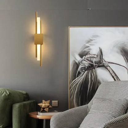 Modern gold led wall sconce with vertical cylindrical bars and central square panel for bedroom lighting decorbites gold led wall