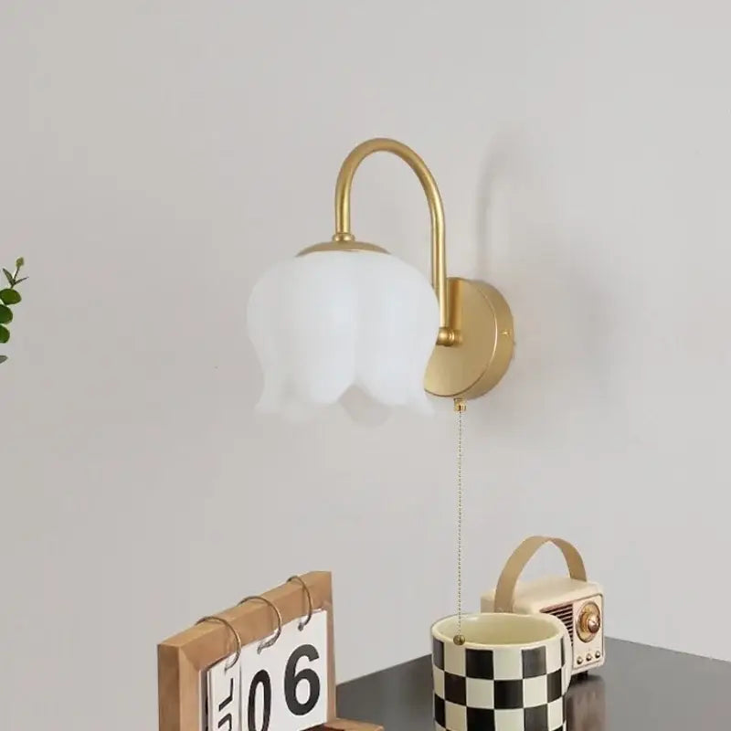 Modern gold led wall sconce with frosted glass tulip shade for stairway lighting