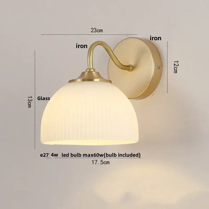 A warm-toned modern gold led wall sconce with brass-finished iron frame and ribbed frosted glass for stairway lighting