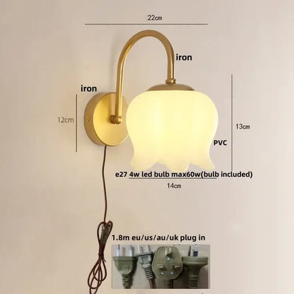 Modern gold led wall sconce with a frosted glass tulip-shaped shade for elegant stairway lighting