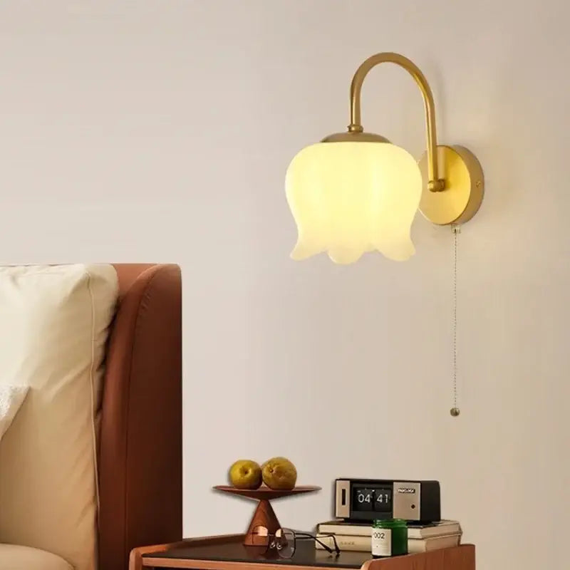 Modern gold led wall sconce with frosted glass tulip shade designed for decorative stairway lighting