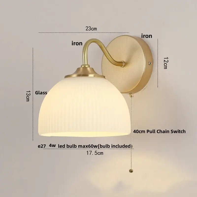 Modern gold led wall sconce with vintage brass finish and frosted glass shade featuring vertical ridges for stairway lighting