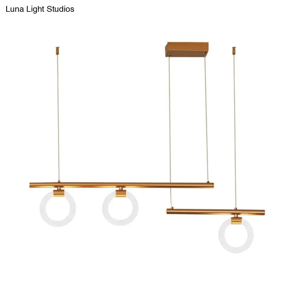 Modern brass-finished linear chandelier lamp with three circular frosted glass shades suspended by thin cables