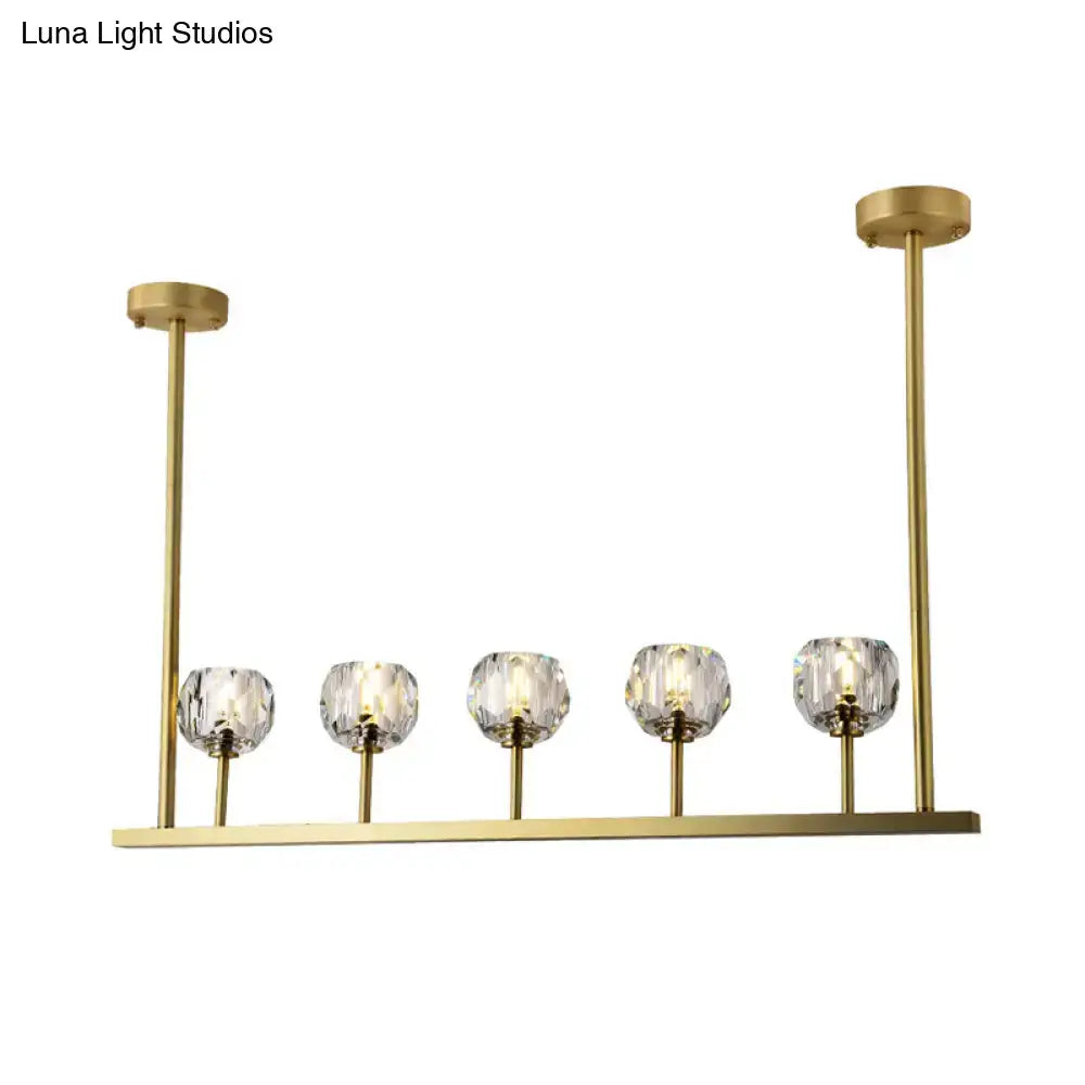 Gold-toned decorbites™ 5-head linear crystal ball pendant light with five faceted crystal globe shades for dining rooms