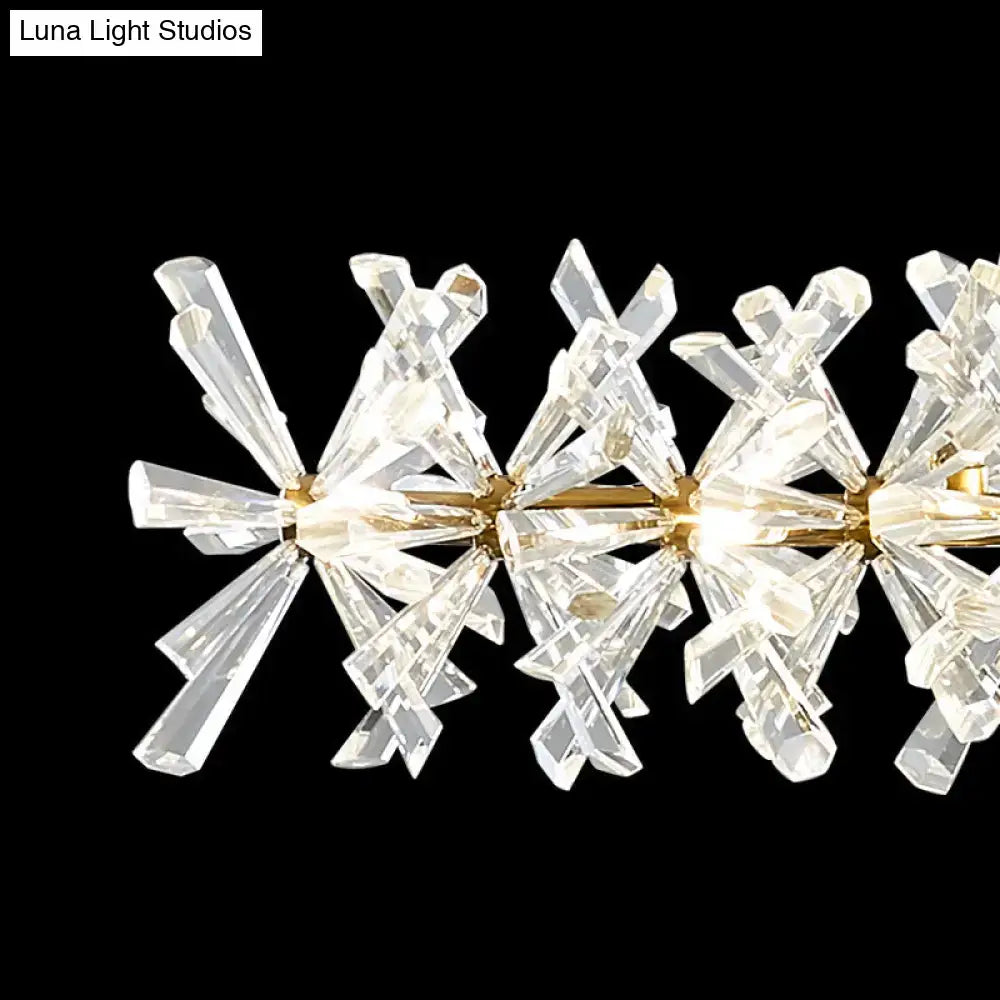 Modern gold linear crystal island lamp with faceted prisms and gold-toned arms for living room fixture width