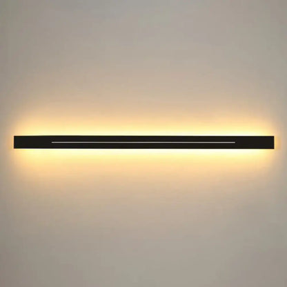 Modern gold linear led wall light fixture with black rectangular led wall light sconce emitting warm ambient light