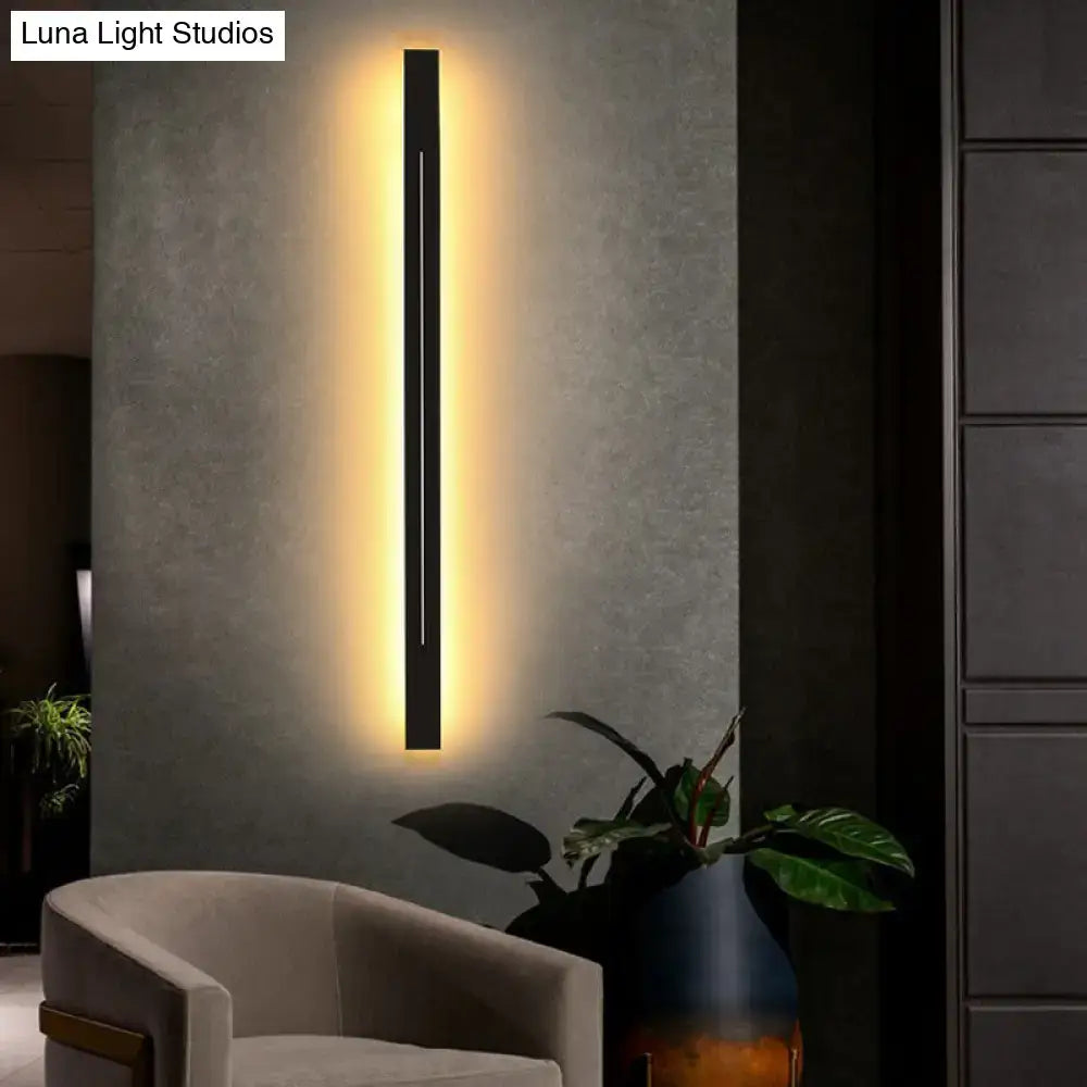 Modern black linear wall light fixture with warm ambient lighting ideal for contemporary living room sconces