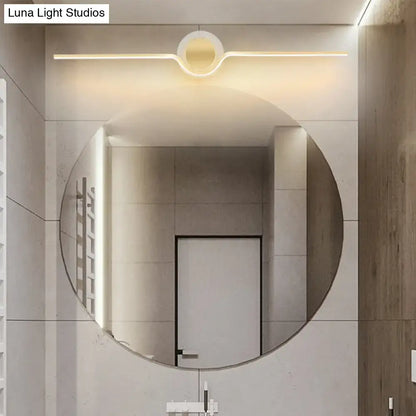 Modern gold linear LED wall sconce with maximum bulb wattage, featuring circular mirror and integrated warm LED lighting