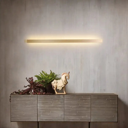 Modern gold linear wall light fixture with a gold-toned rectangular led minimalist wall light fixture for stairway ambient lighting