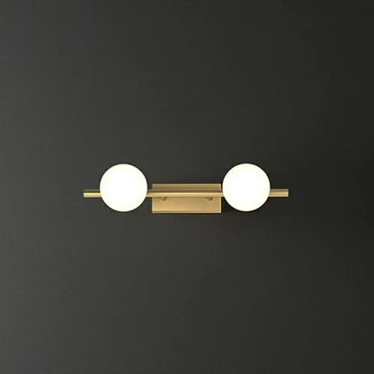 Modern gold linear wall sconce with two spherical milky ball glass globes for bathroom lighting