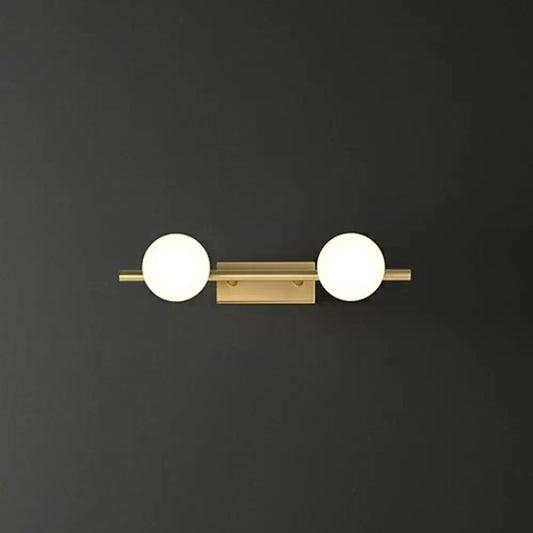 Modern gold linear wall sconce with two spherical milky ball glass globes for bathroom lighting