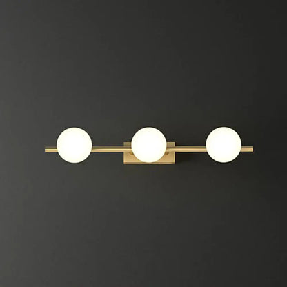 Modern gold linear wall sconce with three frosted milky ball glass globe bulbs for bathroom lighting