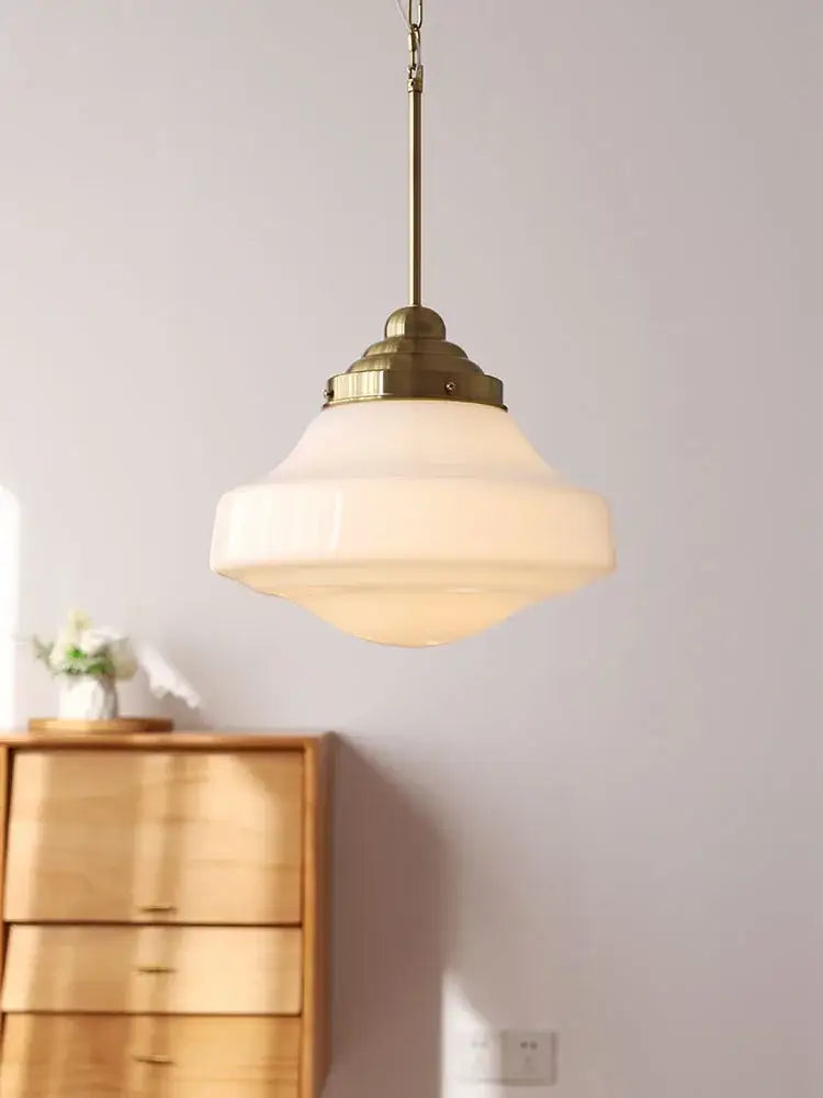 A warm frosted glass tiered shade pendant light with brass gold lustre fixture by decorbites for kitchen decor