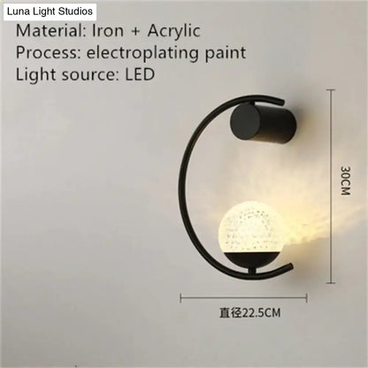 Black iron and acrylic led bedside wall sconce with curved arm and illuminated textured globe for luxury creative led use