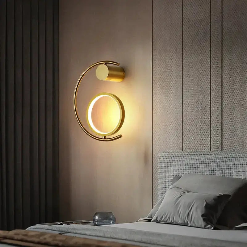 Modern gold luxury creative led bedside wall sconce with circular illuminated ring and curved arm design for bedroom use