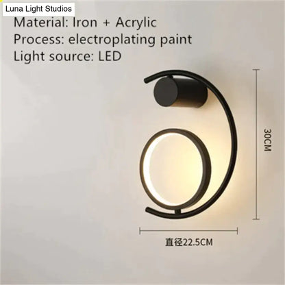 Black iron and acrylic wall sconce with sleek curved design featuring luxury creative led bedside light source