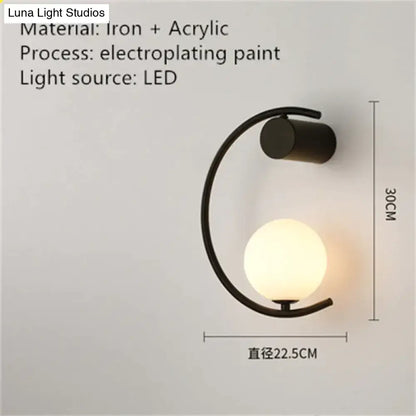 Modern gold luxury creative led bedside wall lamp with black iron curved arm and frosted acrylic globe sconce