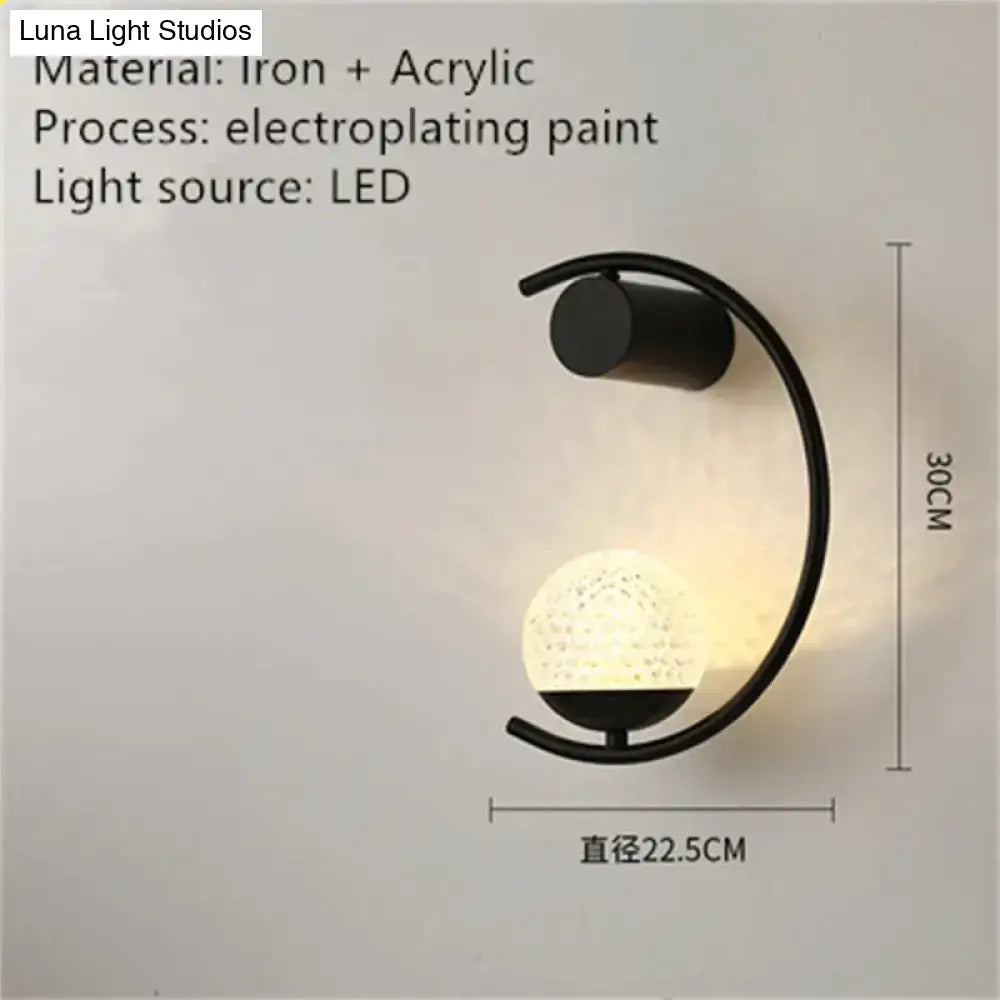 Black iron and acrylic luxury creative led bedside wall lamp with curved arm and illuminated textured globe sphere