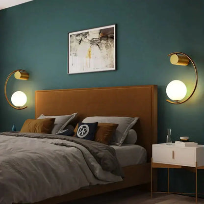 Modern gold luxury creative led bedside wall lamp with crescent gold-toned sconce and frosted glass globe bulbs