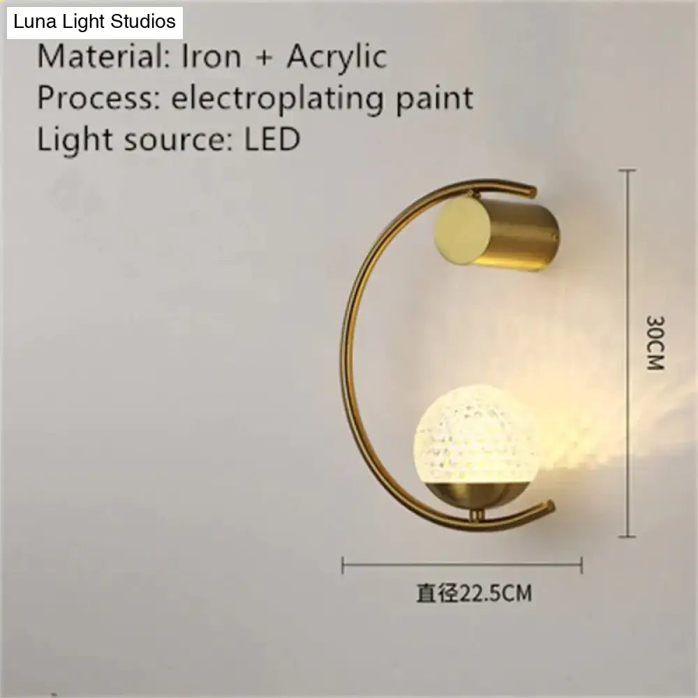 Modern gold luxury creative led bedside wall lamp with curved iron frame and acrylic globe diffuser for bedroom use