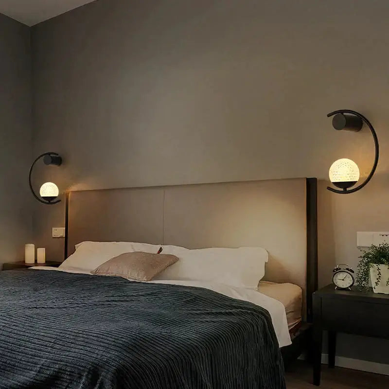 Black curved luxury creative led bedside wall lamp with spherical textured glass shades for bedroom sconce use