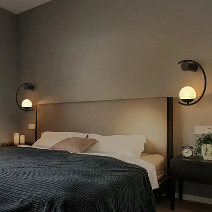 Black curved luxury creative led bedside wall lamp with spherical textured glass shades for bedroom sconce use