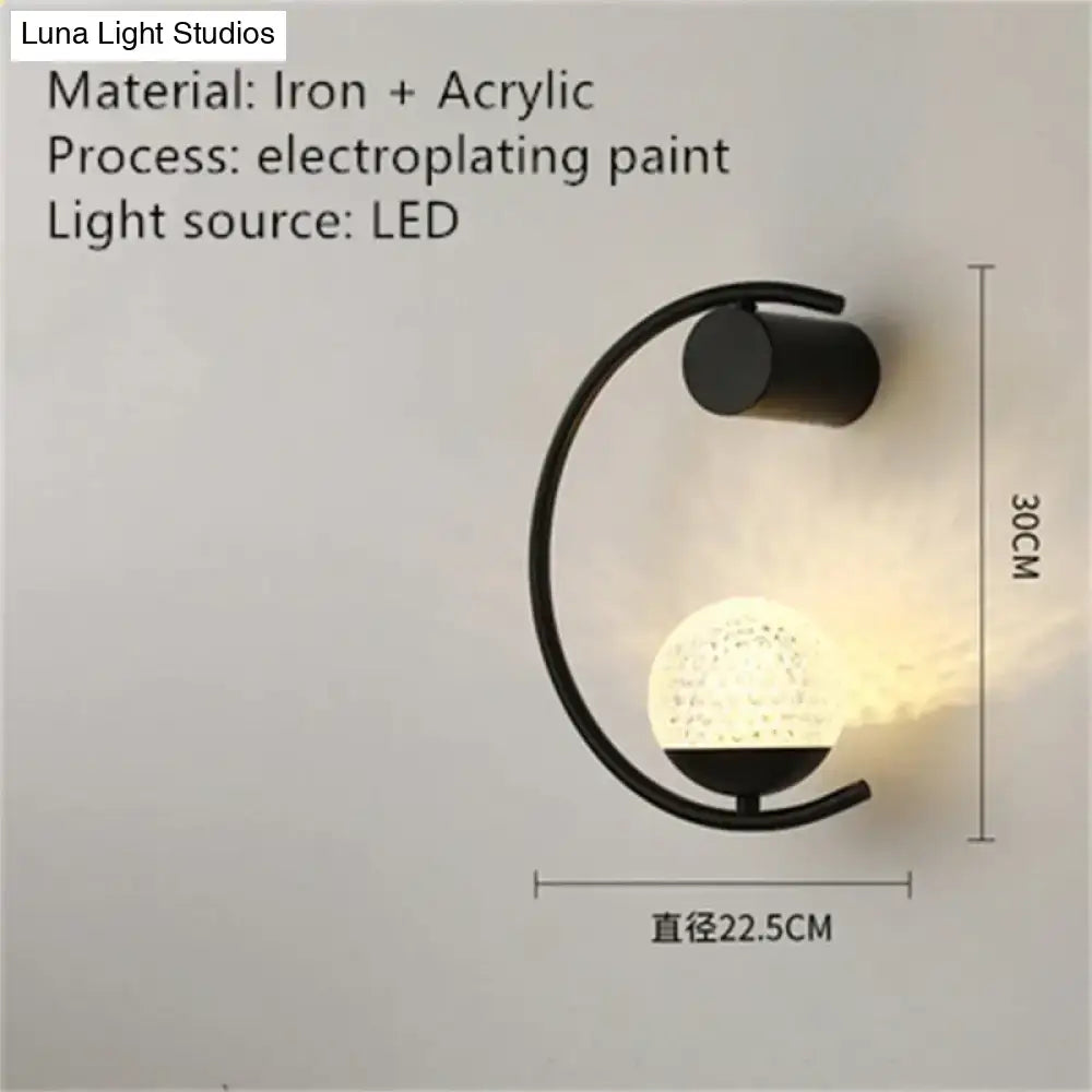 Black iron and acrylic luxury creative led bedside wall sconce with curved arm and textured illuminated globe