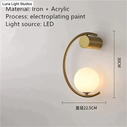 Modern gold luxury creative led bedside wall lamp with curved iron frame and frosted acrylic globe for bedroom sconce