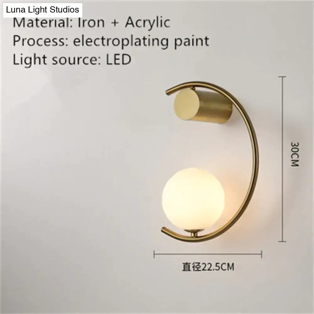 Modern gold luxury creative led bedside wall lamp with curved iron frame and acrylic globe shade for bedroom use