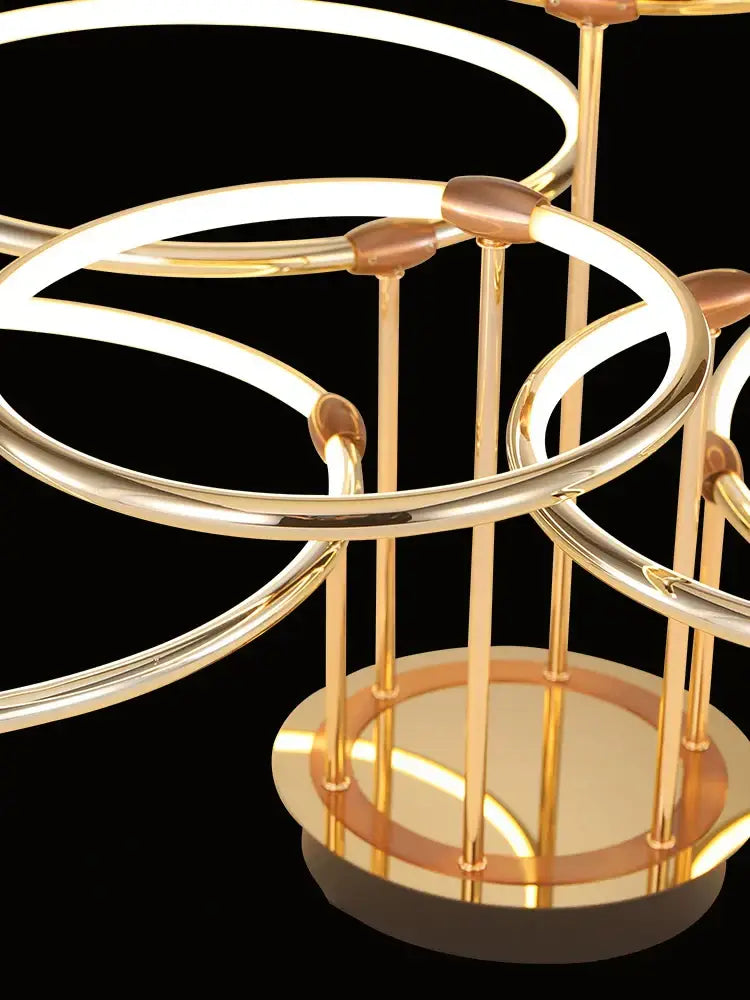 Modern gold luxury ring pendant chandelier with interlocking circular hoops and vertical rods for dining room decorbites gold luxury