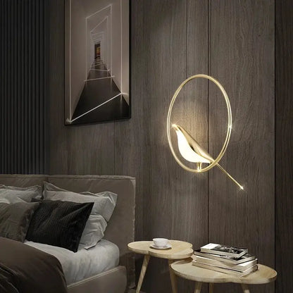 Modern gold magpie bird ceiling chandelier featuring a gold-toned bird-shaped wall sconce with glowing interior light