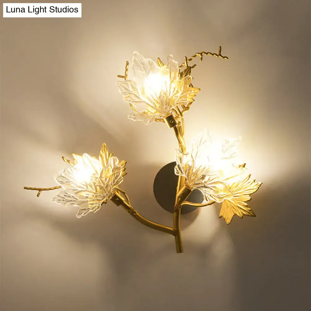 Modern gold maple leaf wall lighting fixture with translucent glass flower shades and delicate branch-like metal arms