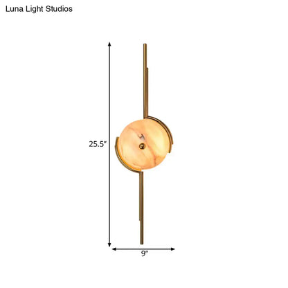 Modern gold marble led wall light featuring a warm amber marble disc and polished brass for bedroom use