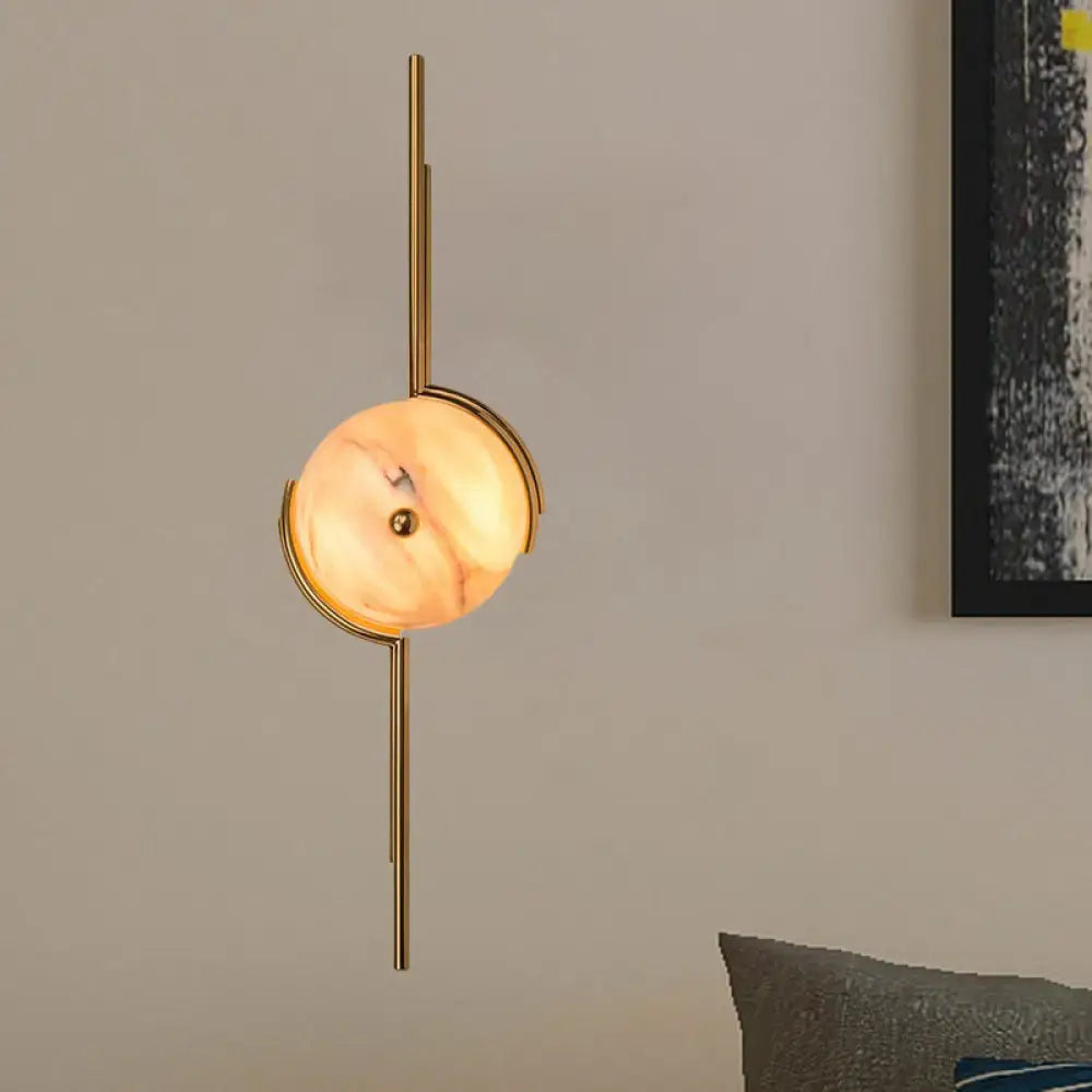 Modern gold marble led wall light featuring a gold-toned light fixture with a circular warm marble shade for bedroom use