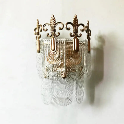 Antique brass and clear cut glass wall light with ornate fleur-de-lis detailing for 110v-120v or 220v-240v use