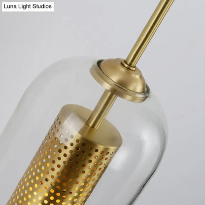 Modern gold mesh and clear glass sconce wall lamp featuring a gold-toned metal pendant with perforated cylindrical shade