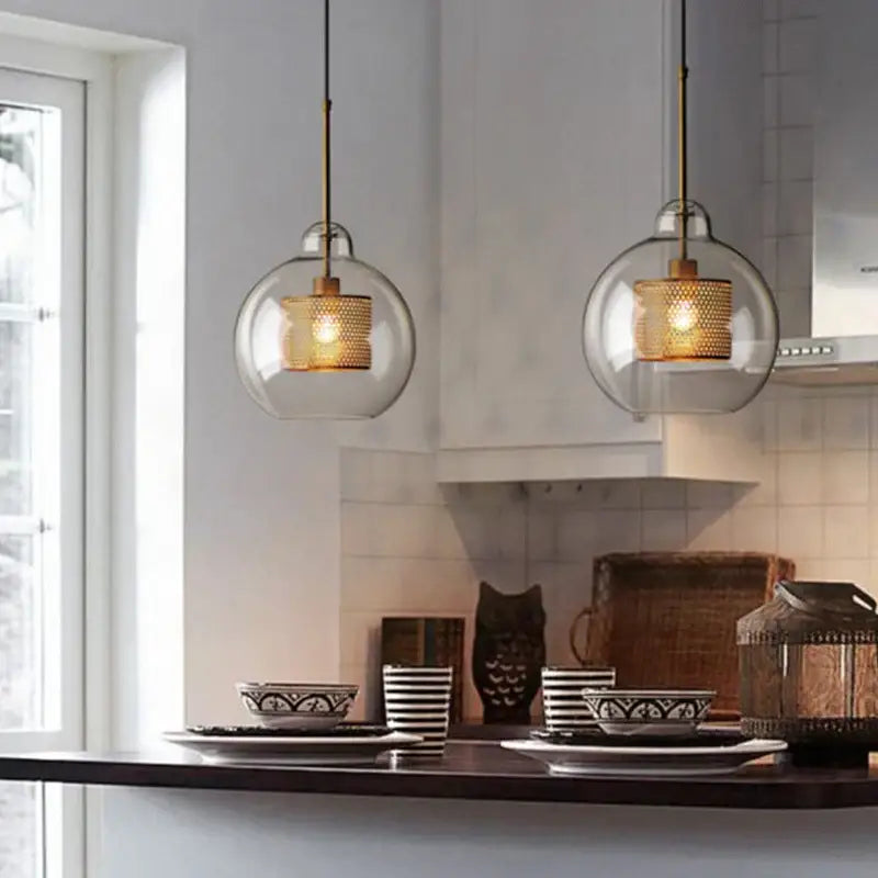 Modern gold mesh glass ball pendant light with brass-finished shades and black cords for kitchen and dining decorbites pendant light